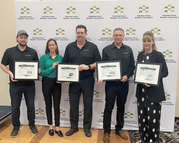 Holding awards certificates: (l-r) Dean, Jade, Adrian, and Hammerdown owners Tyson and Kim Hiebert. Not pictured: team members Cody and Stephanie, both at home with new-borns.