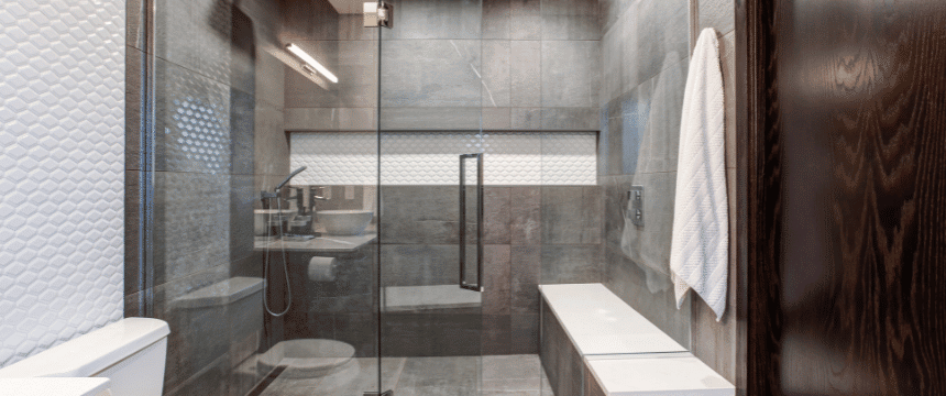 Large walk-in custom tiled shower with bench and edge-to-edge shower niche