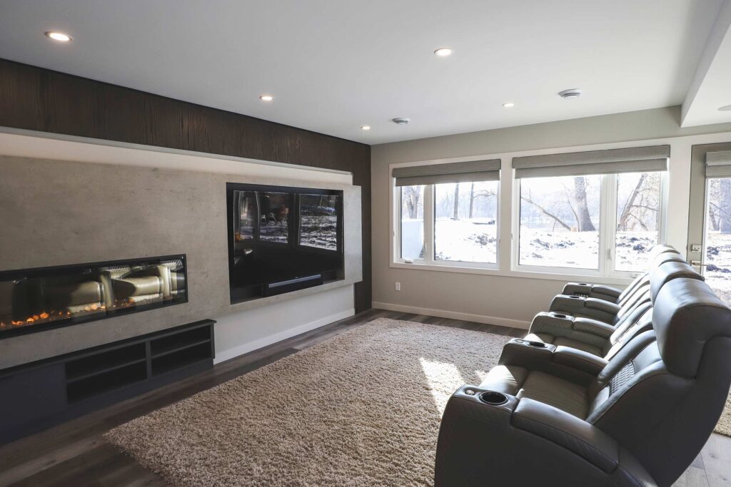 Basement renovation with loungers and fireplace