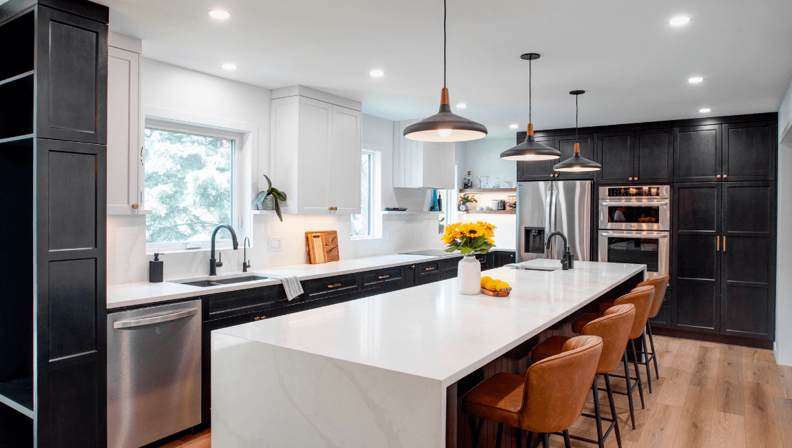 Kitchen renovation with large island with seating and waterfall countertop edges
